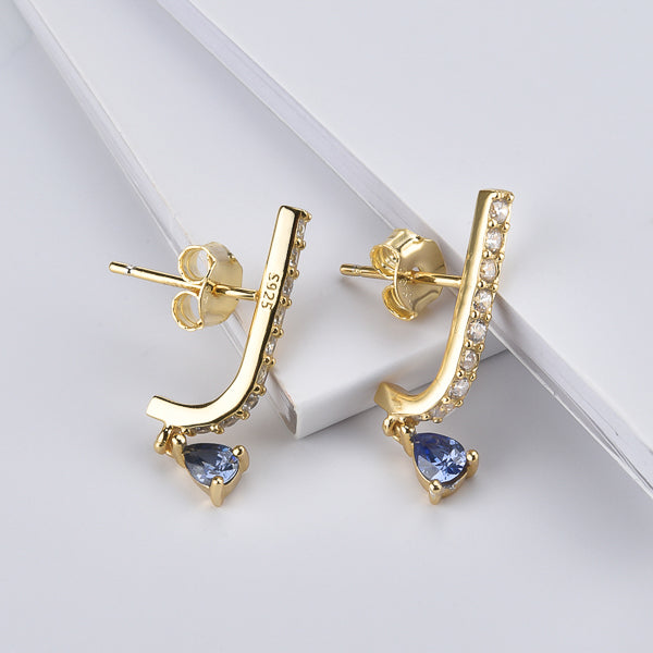 Gold curved bar earrings with blue teardrop charm