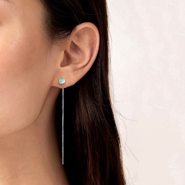 Woman wearing blue opal threader earrings