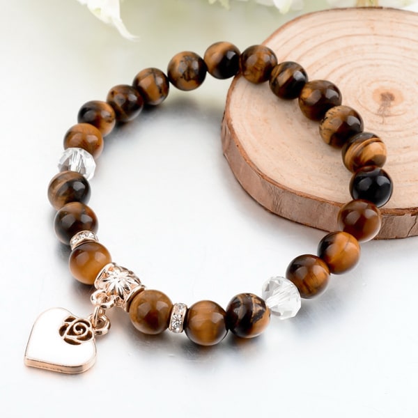 Brown natural stone bracelet with a gold heart charm