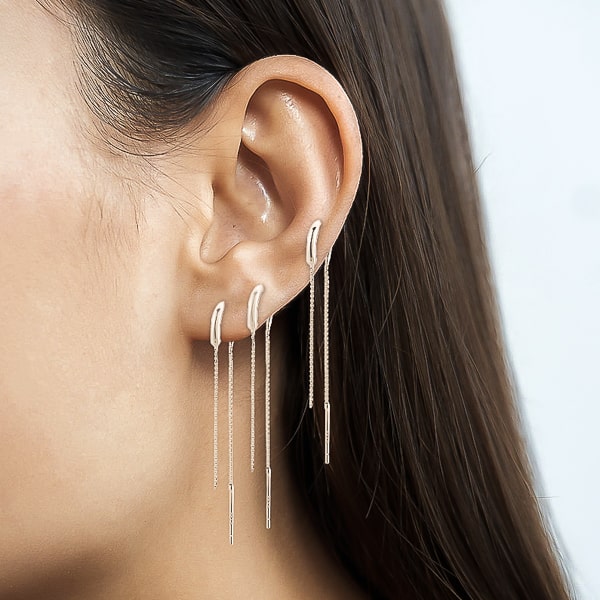 Woman wearing classic silver threader earrings