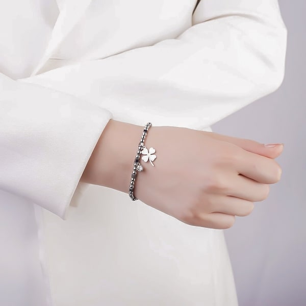 Woman wearing a clover bracelet on her wrist