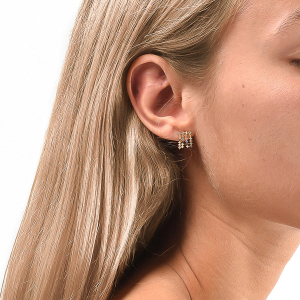 Woman wearing colorful cubic zirconia drop dangle stud earrings