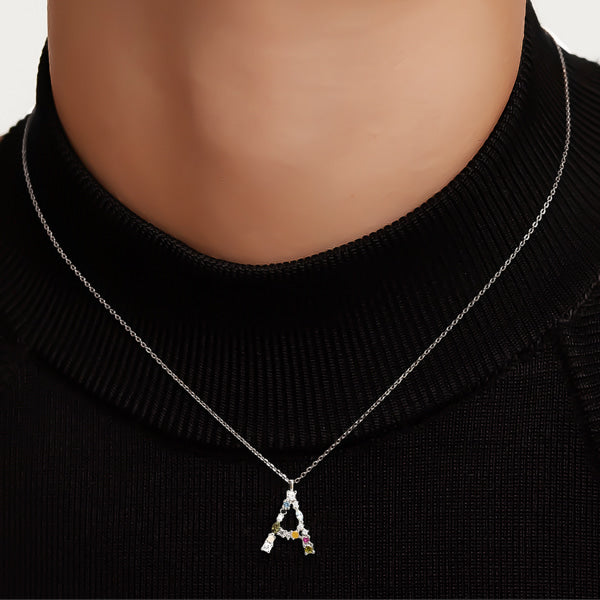 Woman wearing a silver colorful stone initial letter necklace