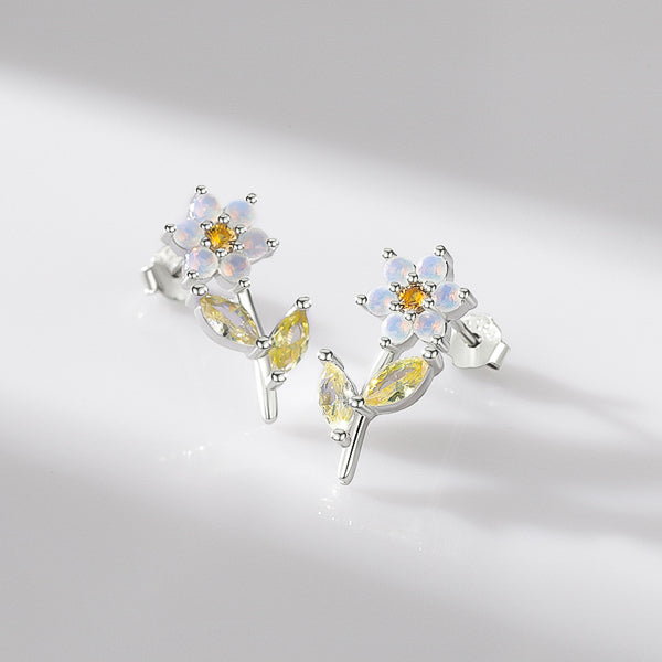 Flower stud earrings made of sterling silver and milky white, orange, and light green crystals