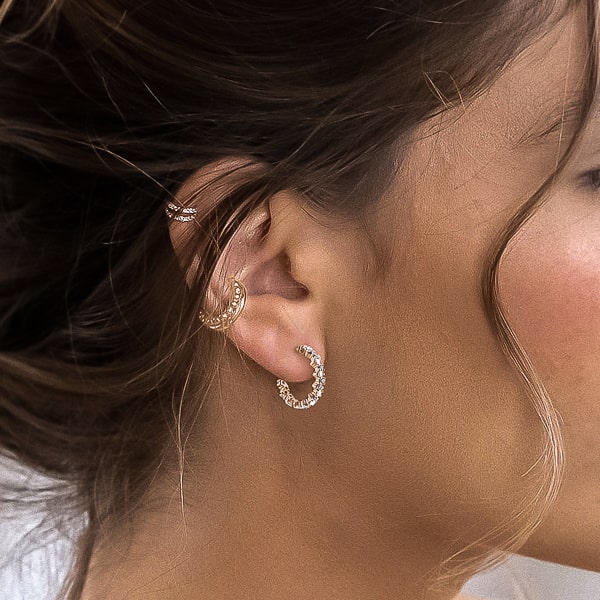 Woman wearing crystal hoop earrings