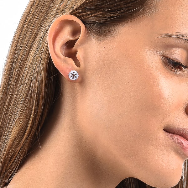 Woman wearing crystal snowflake stud earrings