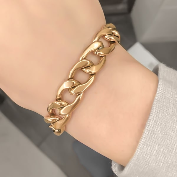 Gold chunky Cuban link chain bracelet on a woman's wrist