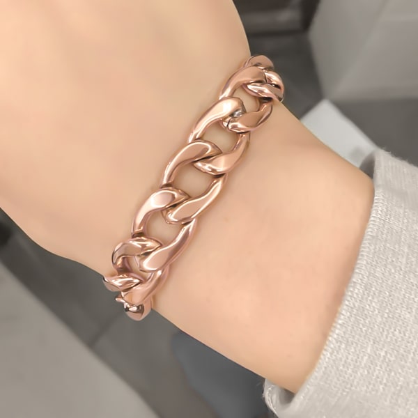 Rose gold chunky Cuban link chain bracelet on a woman's wrist
