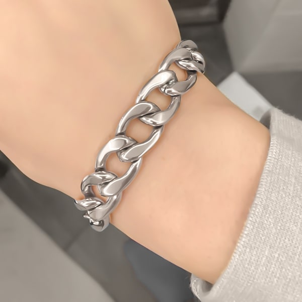 Silver chunky Cuban link chain bracelet on a woman's wrist