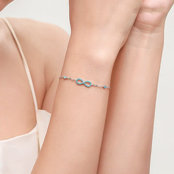 Turquoise infinity bracelet on woman's wrist