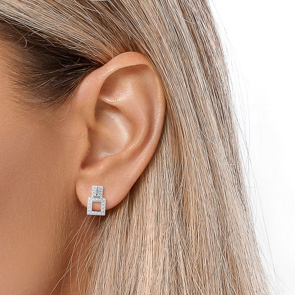 Woman wearing double crystal square stud earrings