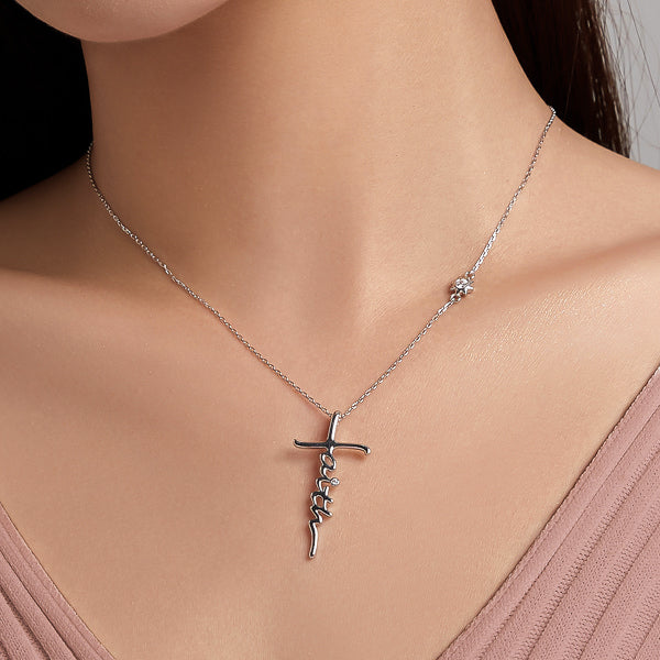 Woman wearing Faith cross necklace