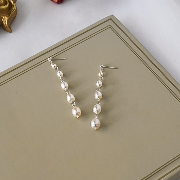 Five pearl drop earrings details