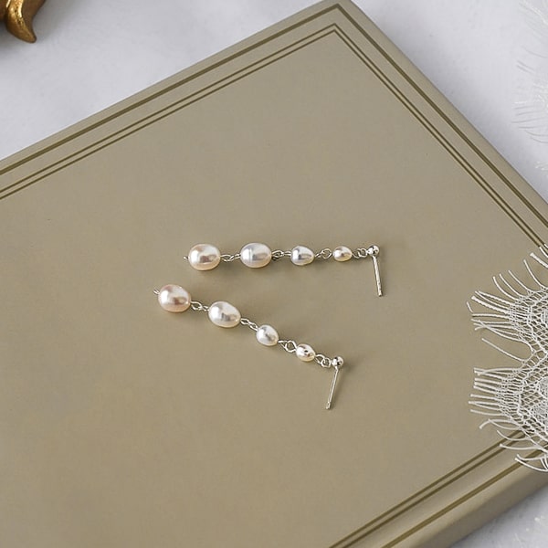 Four pearl drop earrings details