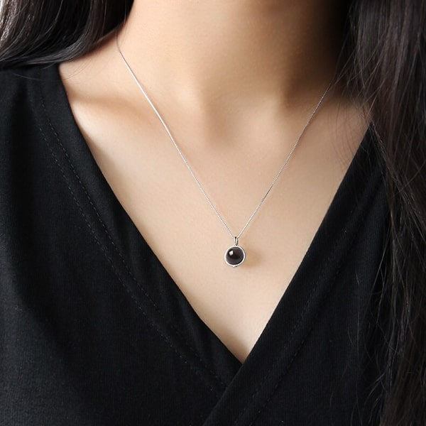 Woman wearing a garnet pendant necklace