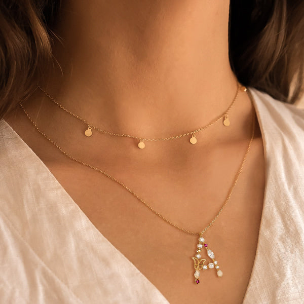 Woman wearing a girly initial letter necklace