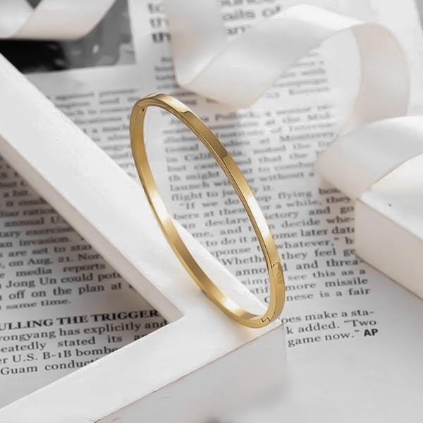 A 4mm gold bangle bracelet made of waterproof hypoallergenic stainless steel
