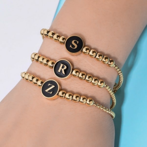 Woman wearing a waterproof gold initial letter bracelet