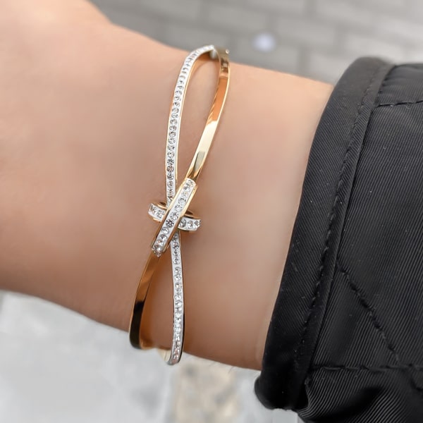 Woman wearing a gold crystal knot bracelet