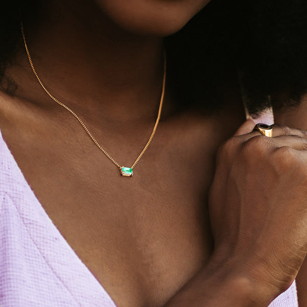 Woman wearing a gold Green Tourmaline bar necklace