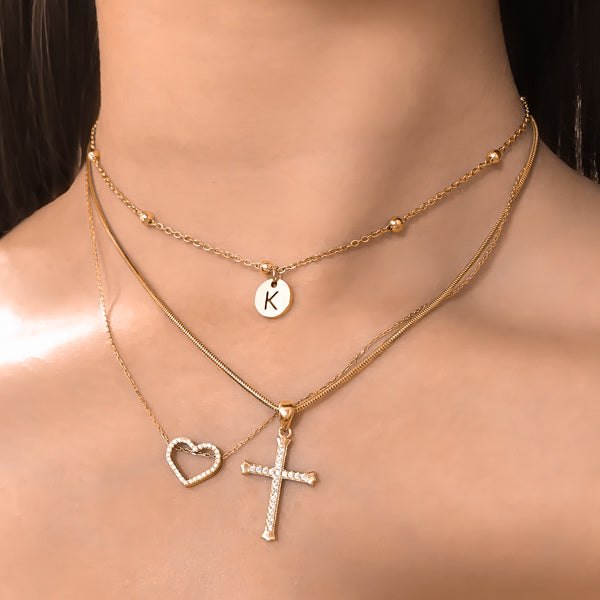 Woman wearing a beaded gold initial disc choker necklace