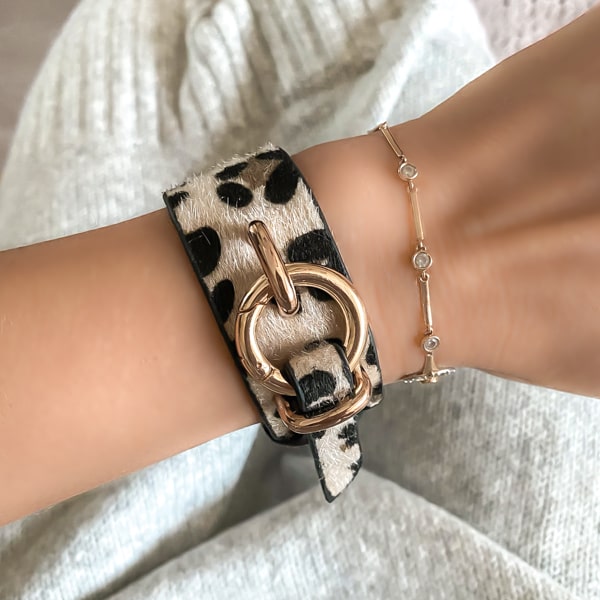Woman wearing a leopard bracelet with gold fashion clasp