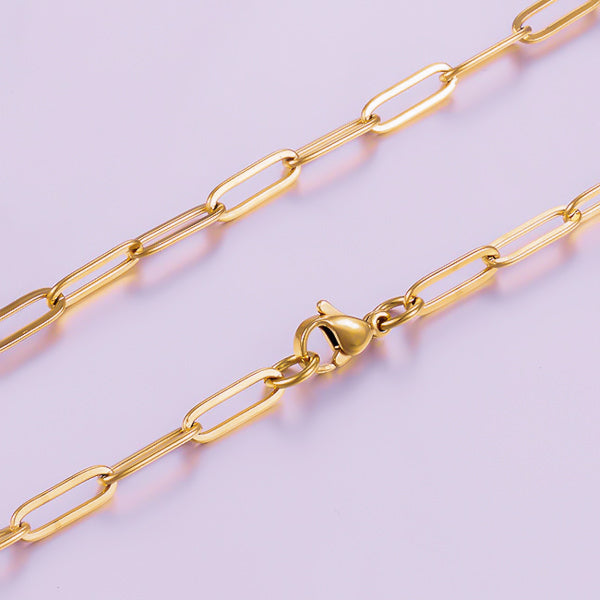 Elongated oval links of the gold paperclip chain necklace photographed up close