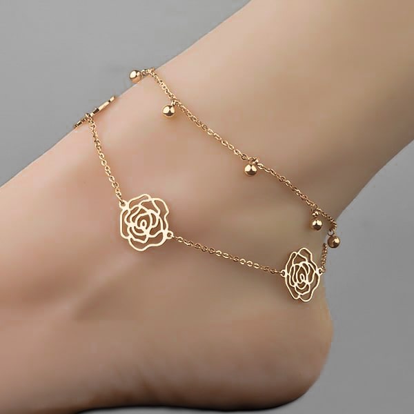 Woman wearing a gold rose flower anklet