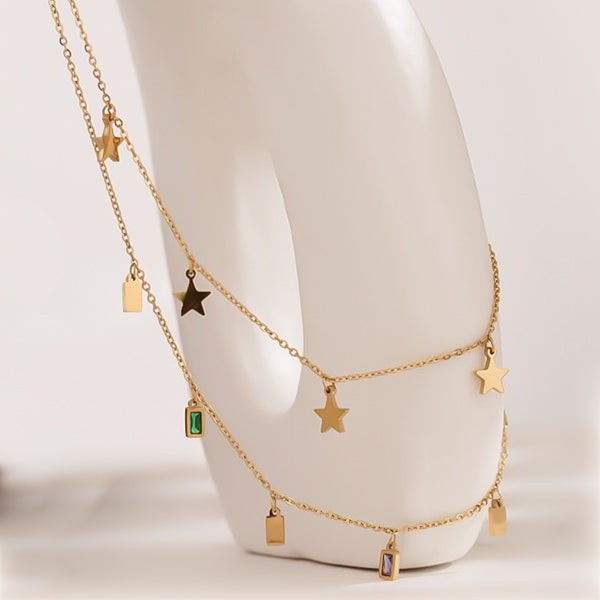Layered necklace with star charms and square crystal pendants
