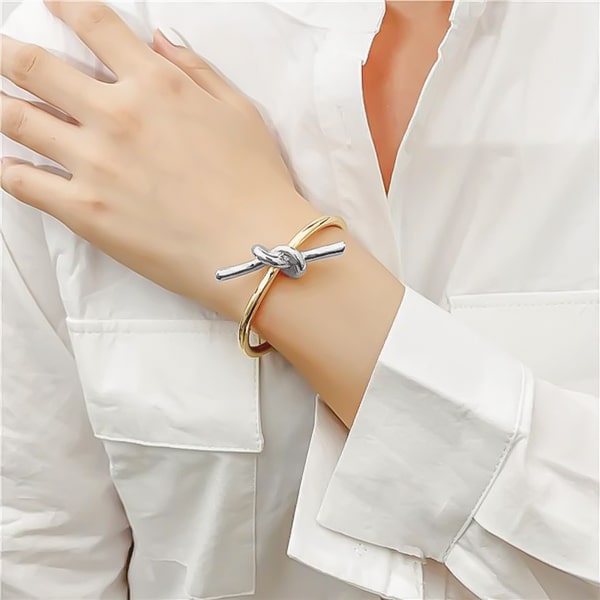 Gold & silver lace knot cuff bracelet dislayed on woman's wrist