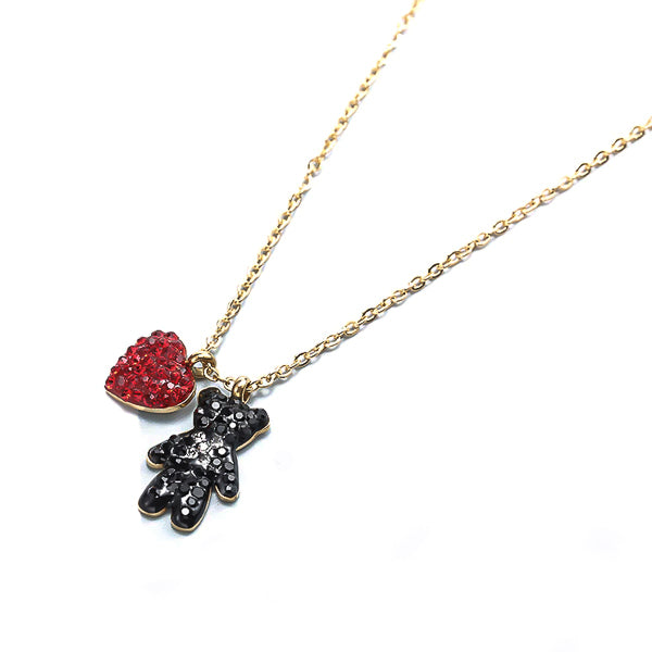 Red crystal heart and black crystal teddy bear pendant on a gold necklace display