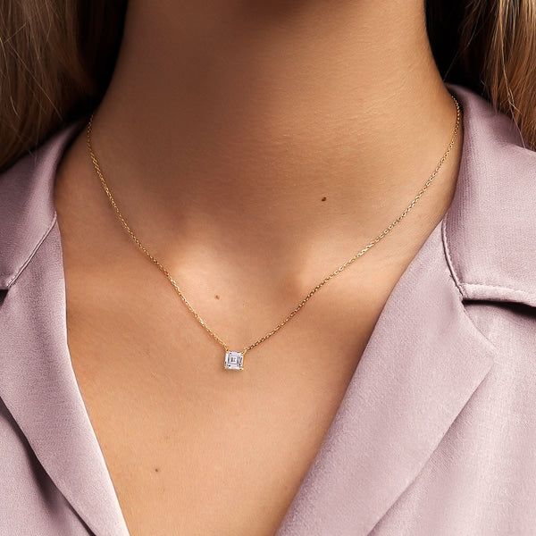 Woman wearing a gold square carre cut crystal necklace