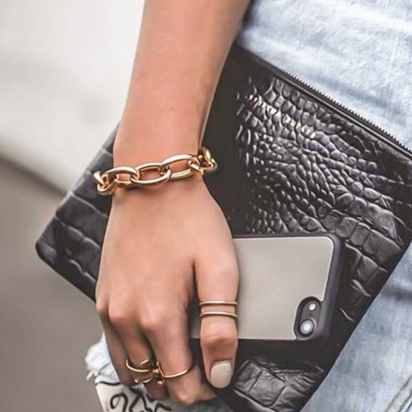 Gold chain cuff bracelet displayed on a woman's wrist