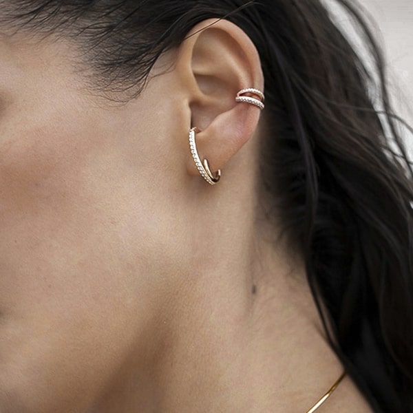 Woman wearing gold climber hoop earrings