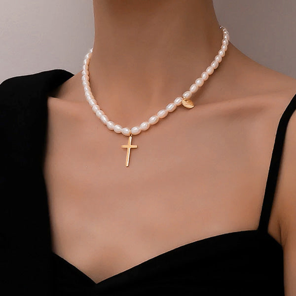 Woman wearing a gold cross freshwater pearl necklace