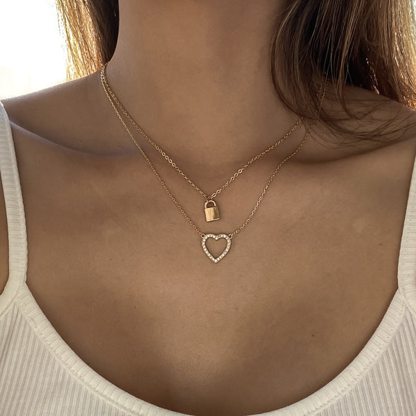 Woman wearing a gold crystal open heart necklace
