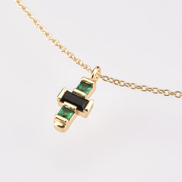 Dainty green & black crystal cross on a gold necklace details
