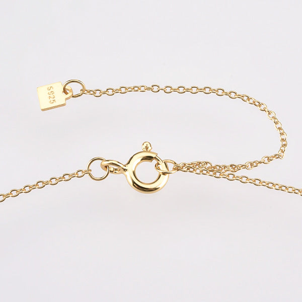 Dainty white & cognac crystal cross on a gold necklace lock