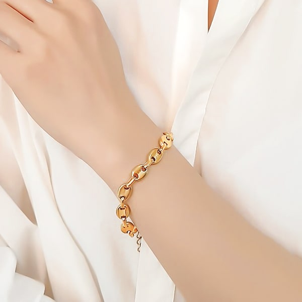Gold designer cable chain bracelet on a woman's wrist