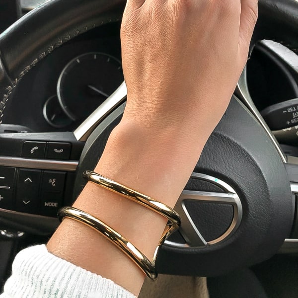 Gold divine cuff bracelet on a woman's wrist