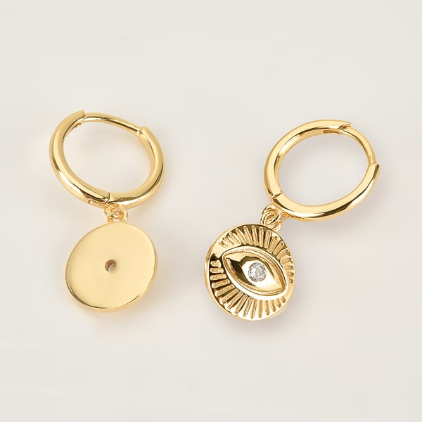 Gold eye of luck huggie hoop earrings detail
