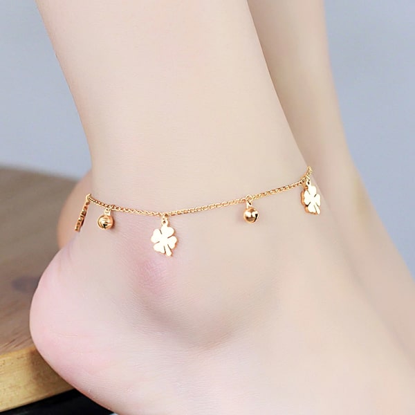Gold four-leaf clover anklet on a womans ankle
