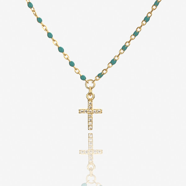Gold necklace with green beads and a crystal cross details