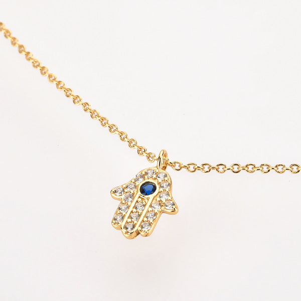 Gold hamsa necklace display