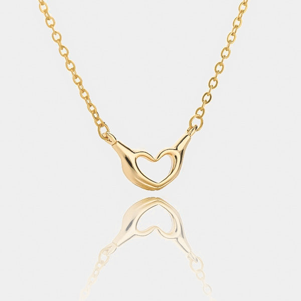 Gold heart hand sign necklace details