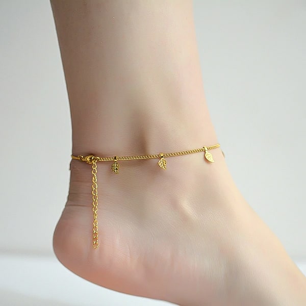 Gold leaf lucky charm anklet on a woman's ankle