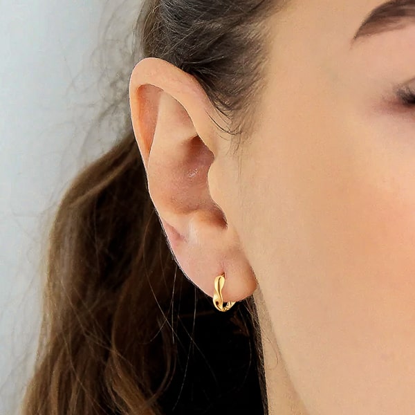 Woman wearing gold mini double twist hoop earrings