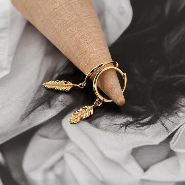 Gold mini feather drop hoop earrings detail