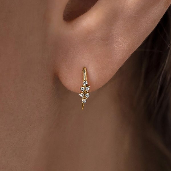 Woman wearing gold mini huggie threader earrings