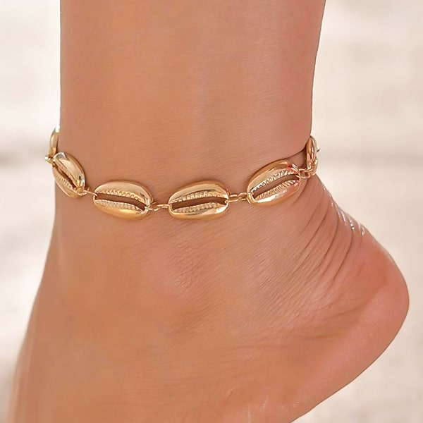 Gold shell anklet on a womans ankle